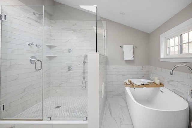 bathroom featuring shower with separate bathtub, tile walls, and vaulted ceiling