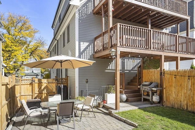 rear view of house featuring a patio and a wooden deck