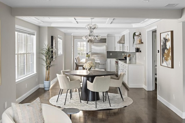 dining space with an inviting chandelier, ornamental molding, coffered ceiling, dark hardwood / wood-style flooring, and beam ceiling