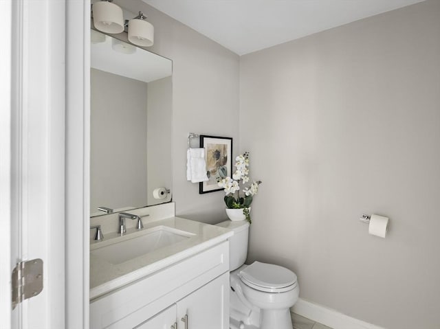 bathroom featuring tile patterned flooring, vanity, and toilet