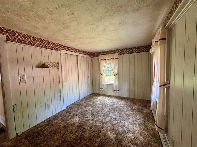20 Birch St, Acushnet, MA 02743 - unfurnished bedroom featuring carpet flooring, a textured ceiling, and wooden walls