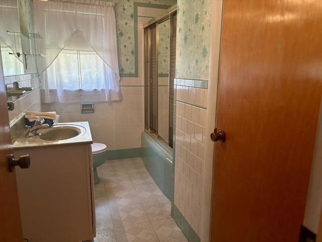 20 Birch St, Acushnet, MA 02743 - full bath featuring toilet, vanity, wallpapered walls, tile walls, and wainscoting