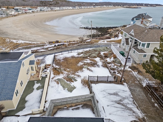 snowy aerial view featuring a water view