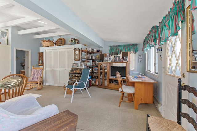 carpeted home office featuring lofted ceiling with beams