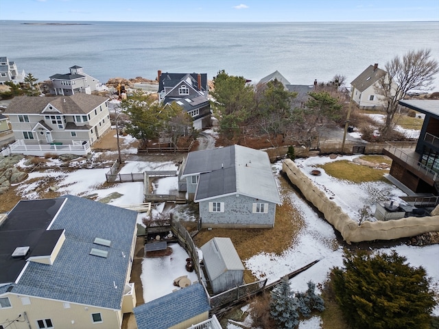 snowy aerial view with a water view