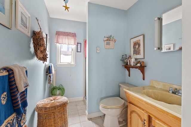 bathroom with an enclosed shower, vanity, tile patterned floors, and toilet