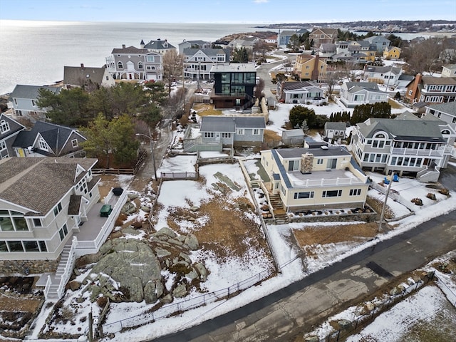 snowy aerial view with a water view