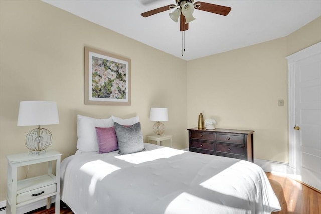 bedroom with ceiling fan and dark wood-type flooring