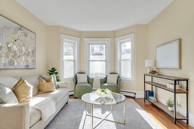 interior space featuring wood-type flooring, a baseboard radiator, and plenty of natural light