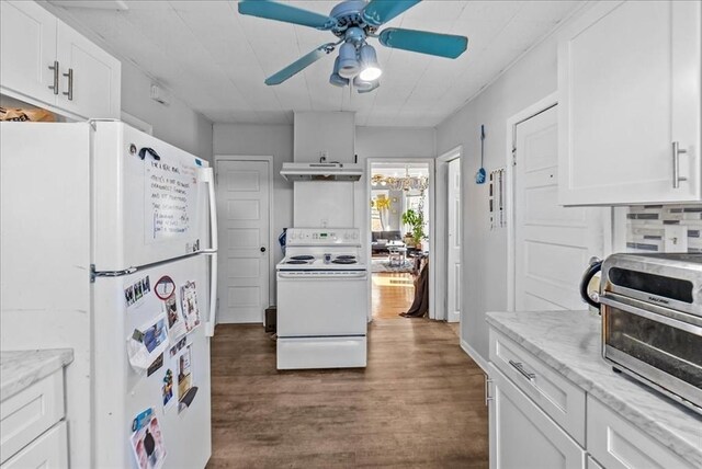 kitchen with white appliances, white cabinets, wood finished floors, and under cabinet range hood