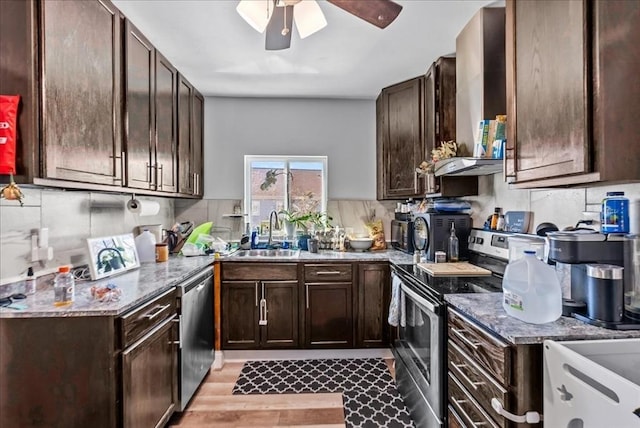 kitchen featuring tasteful backsplash, dark brown cabinets, stainless steel appliances, and a sink