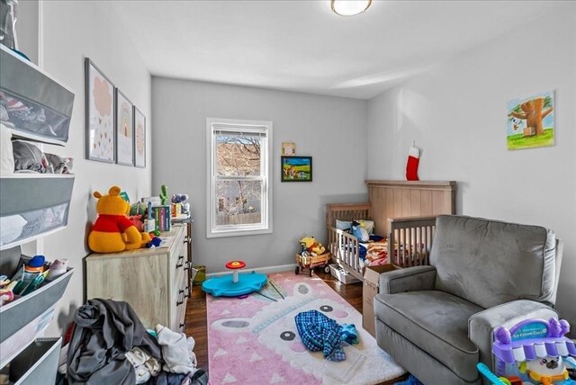bedroom with wood finished floors and baseboards