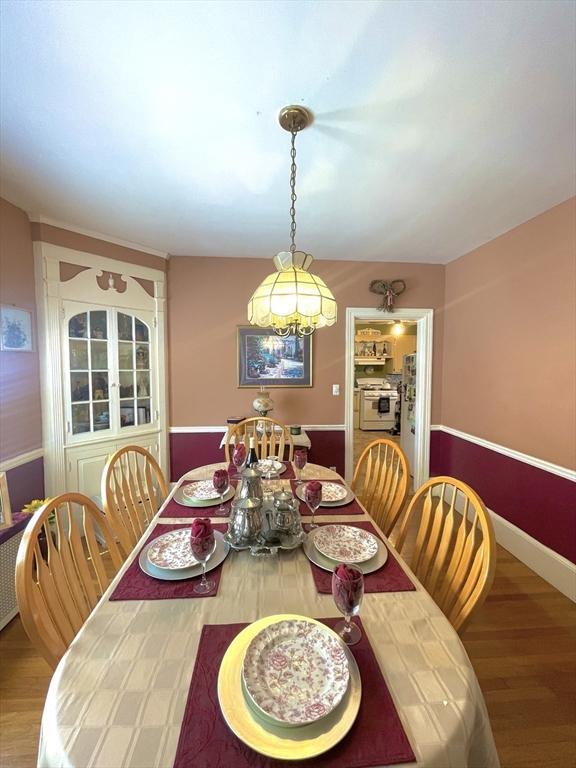 27 Springvale Ave, Lynn, MA 01904 - dining area with wood finished floors and a chandelier