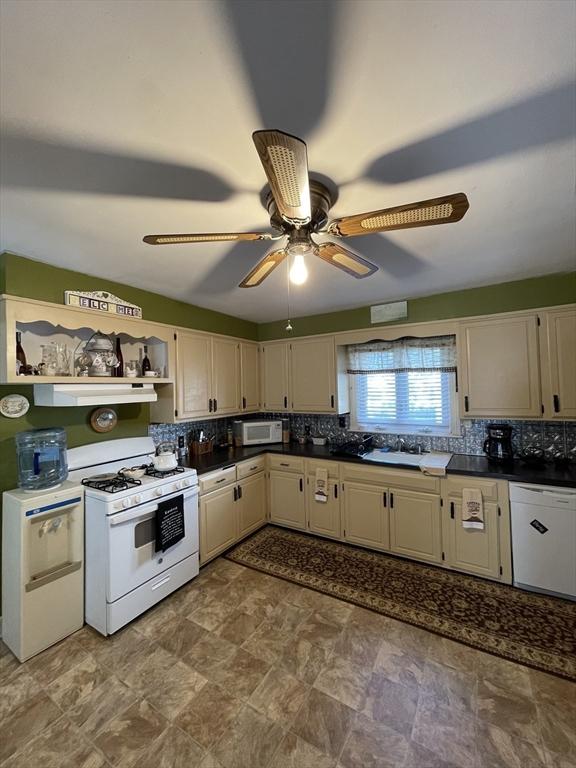 27 Springvale Ave, Lynn, MA 01904 - kitchen featuring white appliances, ceiling fan, decorative backsplash, dark countertops, and open shelves