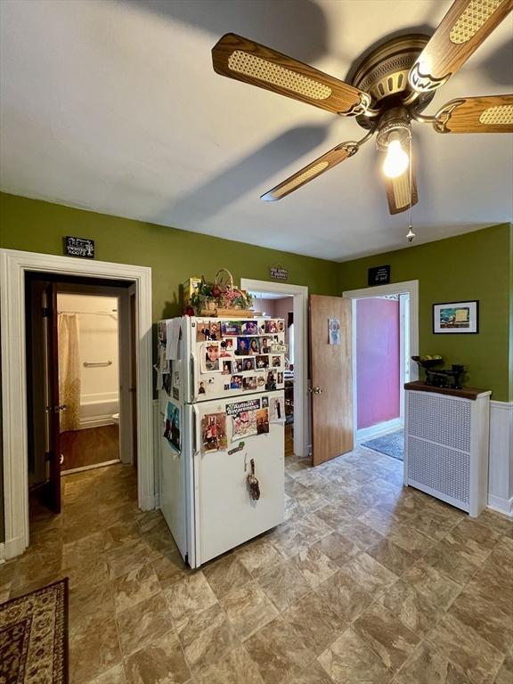 27 Springvale Ave, Lynn, MA 01904 - kitchen with freestanding refrigerator, stone finish floors, and a ceiling fan