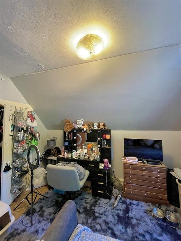 27 Springvale Ave, Lynn, MA 01904 - additional living space featuring lofted ceiling and a textured ceiling
