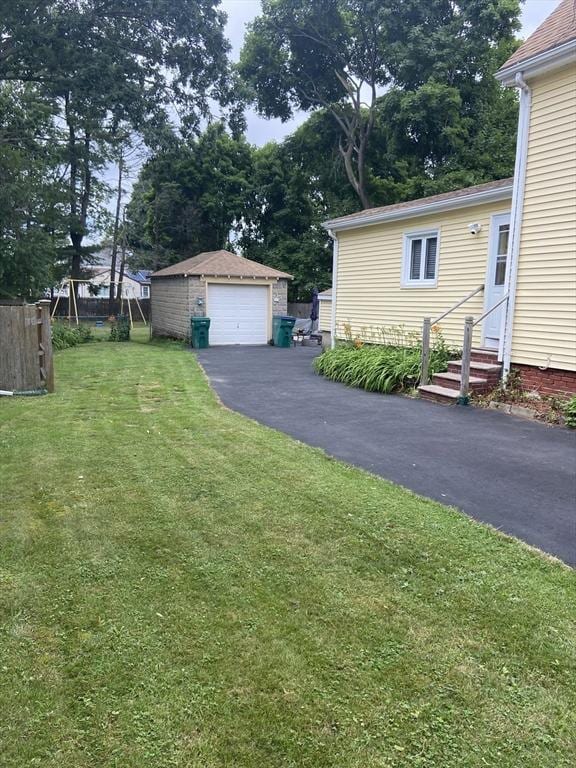 27 Springvale Ave, Lynn, MA 01904 - view of yard with a garage, entry steps, an outdoor structure, and asphalt driveway