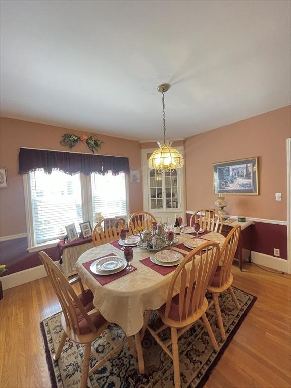 27 Springvale Ave, Lynn, MA 01904 - dining space featuring light wood-style flooring, baseboards, and a chandelier