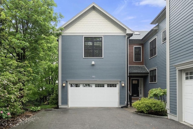 101 Waban St Unit 101, Newton, MA 02458 - view of front facade featuring asphalt driveway and a garage