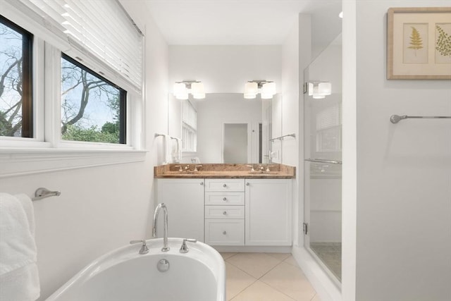 101 Waban St Unit 101, Newton, MA 02458 - bathroom featuring double vanity, tile patterned floors, plenty of natural light, and a bath