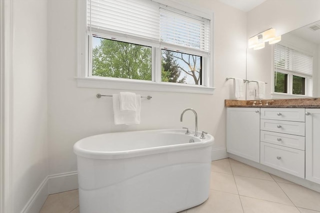 101 Waban St Unit 101, Newton, MA 02458 - full bath with a freestanding bath, vanity, baseboards, and tile patterned flooring