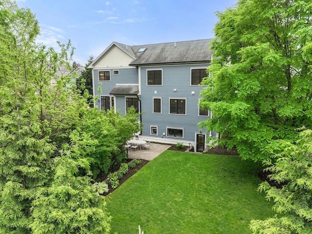 101 Waban St Unit 101, Newton, MA 02458 - rear view of property with a lawn, a patio, and a shingled roof