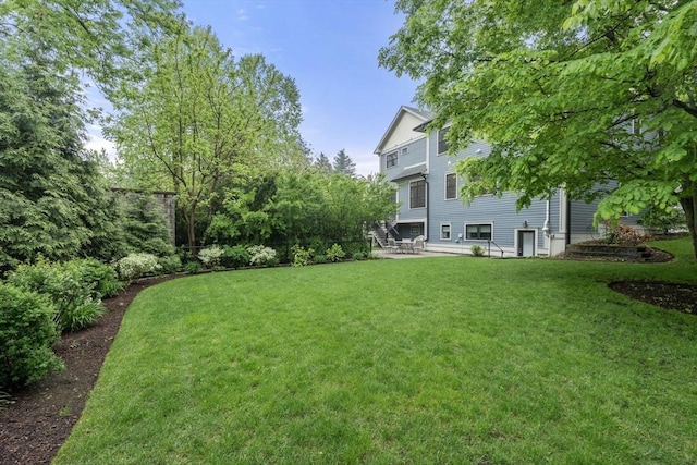 101 Waban St Unit 101, Newton, MA 02458 - view of grassy yard featuring a patio area