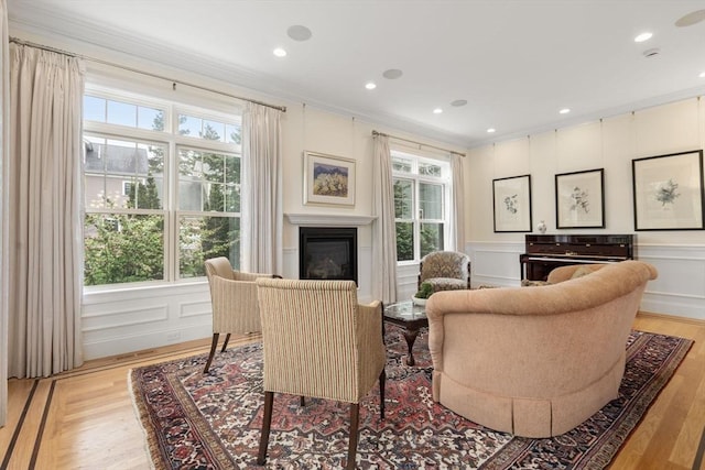 101 Waban St Unit 101, Newton, MA 02458 - living room featuring a decorative wall, crown molding, a glass covered fireplace, light wood-style floors, and recessed lighting