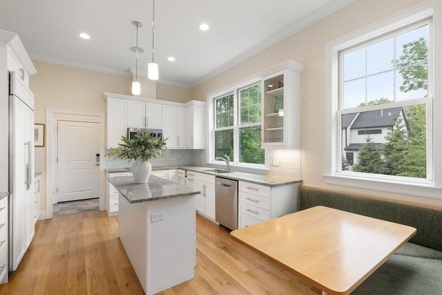 101 Waban St Unit 101, Newton, MA 02458 - kitchen with dishwasher, a kitchen island, tasteful backsplash, white cabinets, and light wood-style flooring