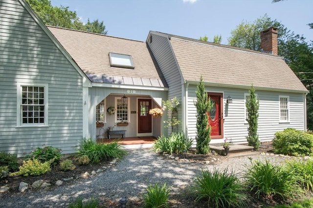 21 Flintlock Ridge Rd, Cohasset, MA 02025 - view of front of home featuring a chimney and covered porch