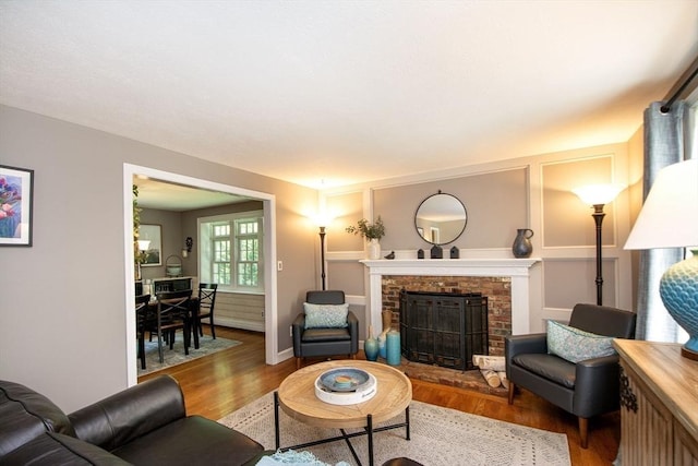21 Flintlock Ridge Rd, Cohasset, MA 02025 - living area featuring wood finished floors and a brick fireplace