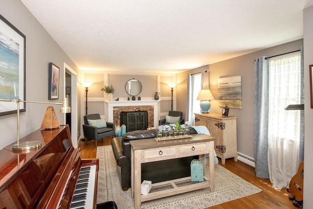 21 Flintlock Ridge Rd, Cohasset, MA 02025 - living area featuring a fireplace, wood finished floors, and a baseboard radiator