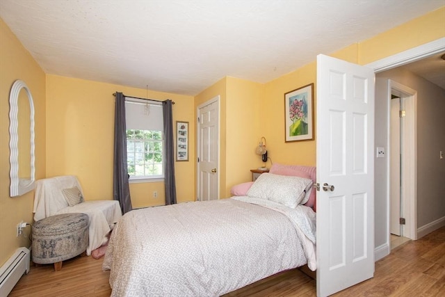 21 Flintlock Ridge Rd, Cohasset, MA 02025 - bedroom featuring baseboard heating and wood finished floors