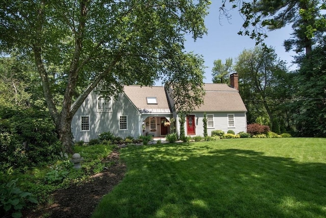 21 Flintlock Ridge Rd, Cohasset, MA 02025 - view of front facade with a front yard and a chimney