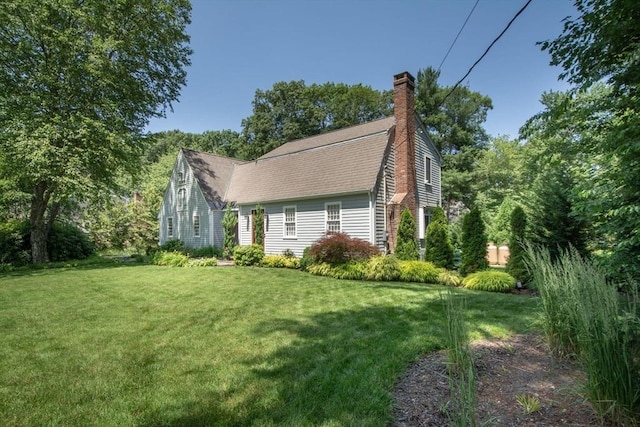 21 Flintlock Ridge Rd, Cohasset, MA 02025 - view of home's exterior with a shingled roof, a chimney, and a lawn
