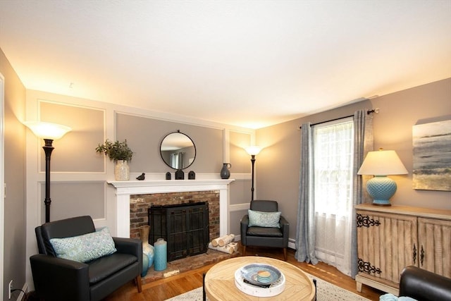 21 Flintlock Ridge Rd, Cohasset, MA 02025 - living room featuring a fireplace, wood finished floors, and a baseboard heating unit