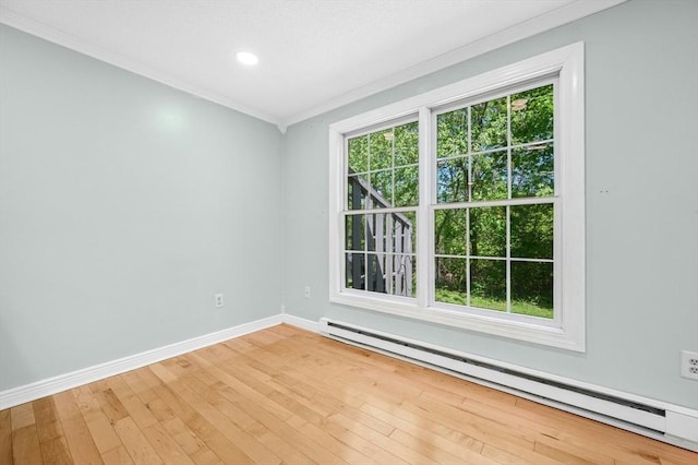 empty room featuring a baseboard radiator, crown molding, baseboards, light wood finished floors, and recessed lighting