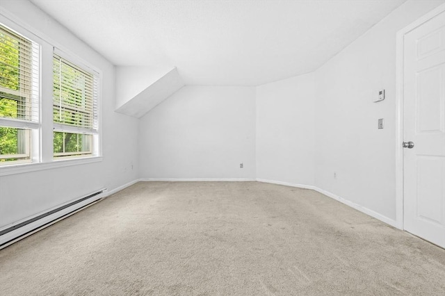 additional living space featuring carpet, baseboard heating, lofted ceiling, and baseboards