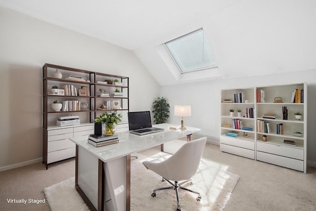 office space with a skylight, light colored carpet, vaulted ceiling, and baseboards