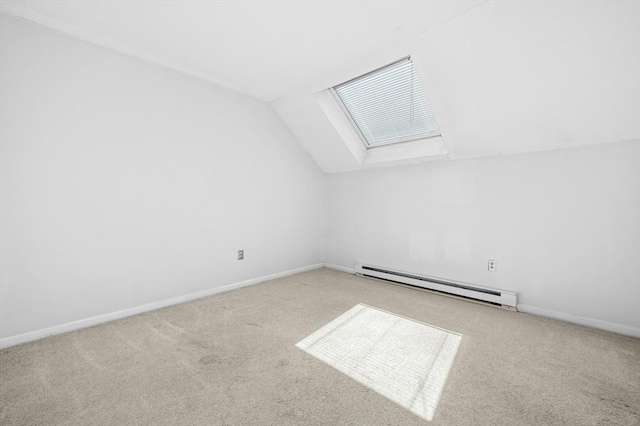 bonus room with baseboard heating, a skylight, vaulted ceiling, carpet flooring, and baseboards