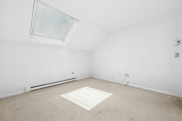 bonus room with a baseboard radiator, vaulted ceiling, carpet flooring, a skylight, and baseboards