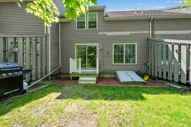 back of property with a lawn