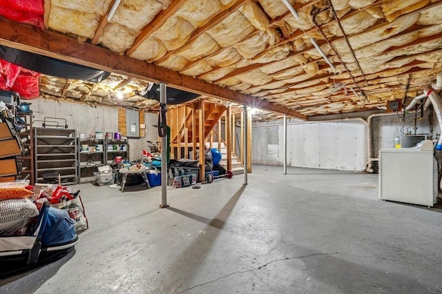 unfinished basement with washer / dryer, stairs, and electric panel