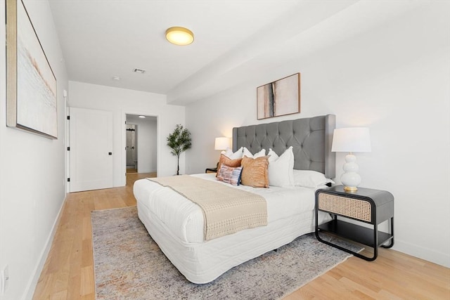 bedroom with hardwood / wood-style flooring