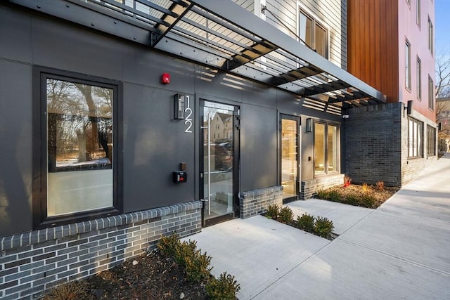 entrance to property featuring a pergola and a patio area