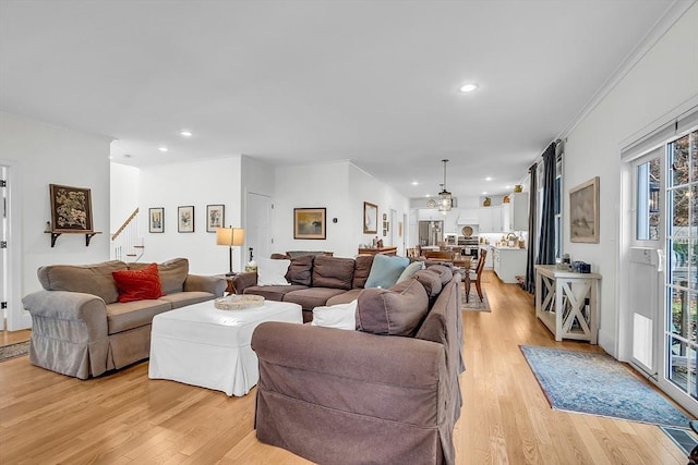 living room with recessed lighting, stairway, and light wood finished floors