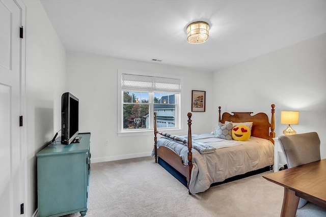 bedroom with visible vents, baseboards, and light colored carpet