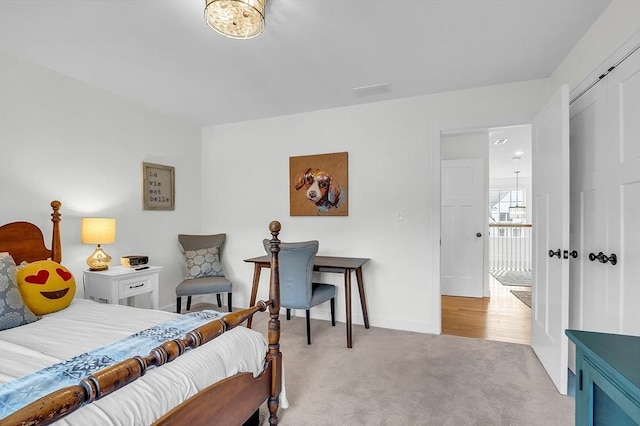 bedroom featuring baseboards and light carpet