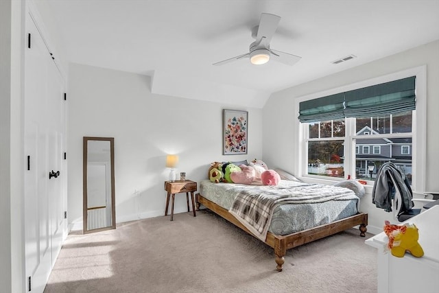 carpeted bedroom featuring visible vents, a ceiling fan, and baseboards