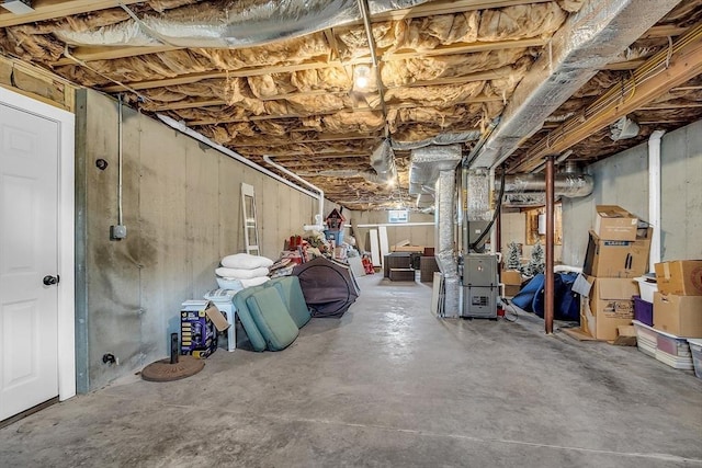 unfinished basement featuring heating unit